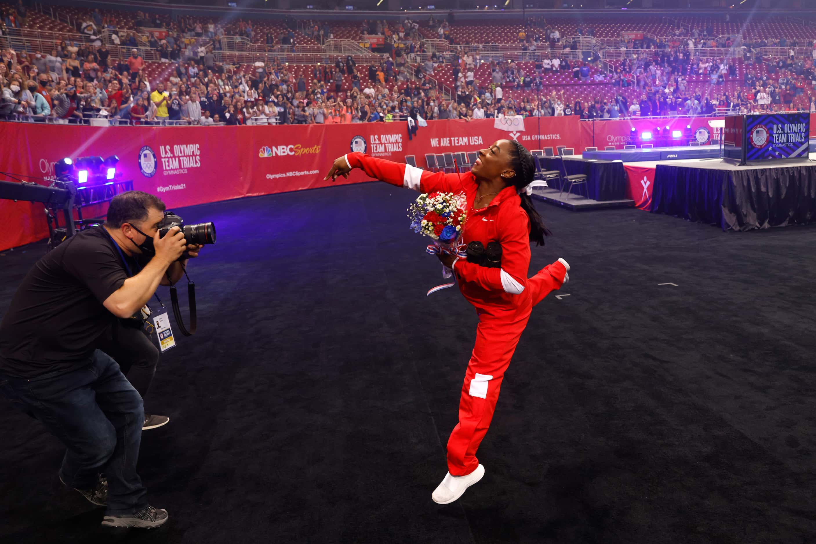 Simone Biles tosses a shirt in the stands after team introductions on day 2 of the women's...