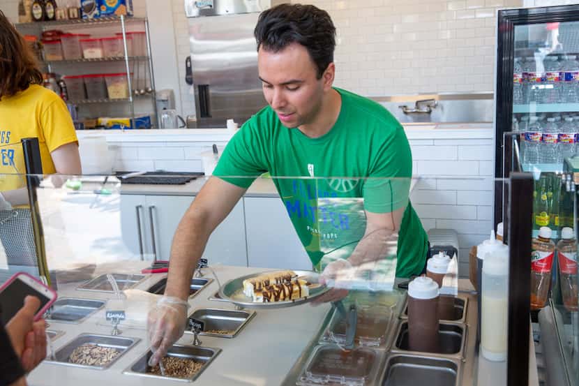 Adrian Lara, co-founder of Picole Pops, prepares a pair of popsicles at the store's Deep...