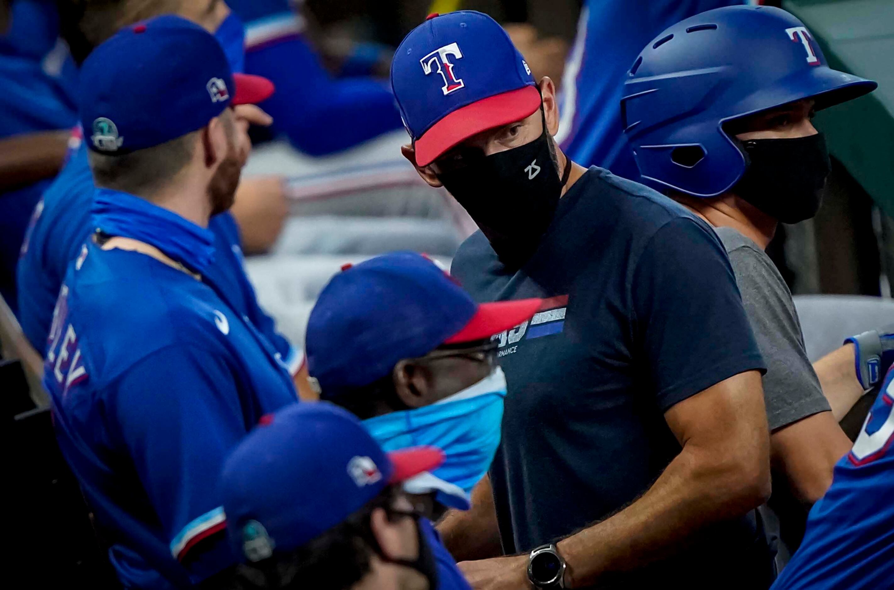 Manager Chris Woodward looks out from the dugout in an intrasquad game during Texas Rangers...