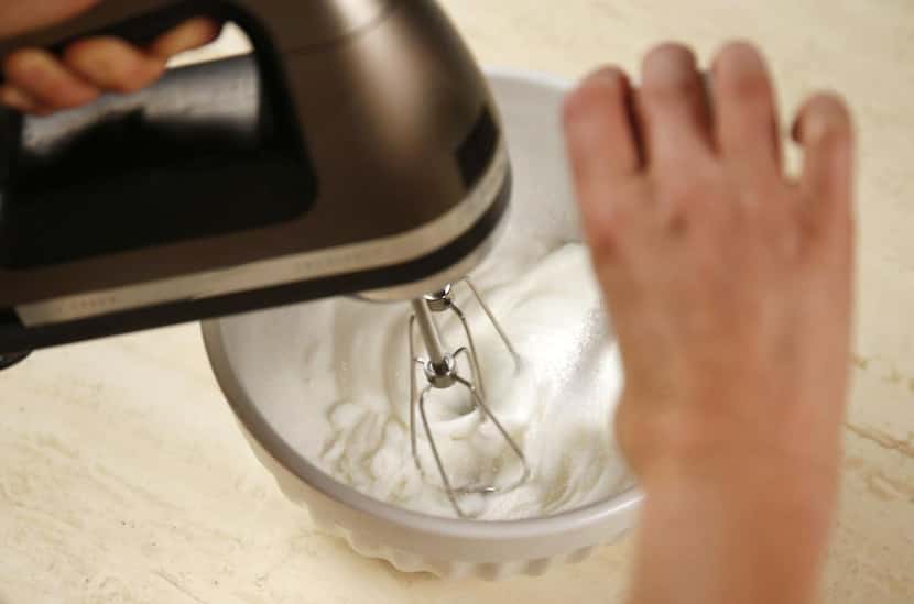 In a separate bowl, whisk the egg whites until stiff peaks form, then slowly add in sugar.