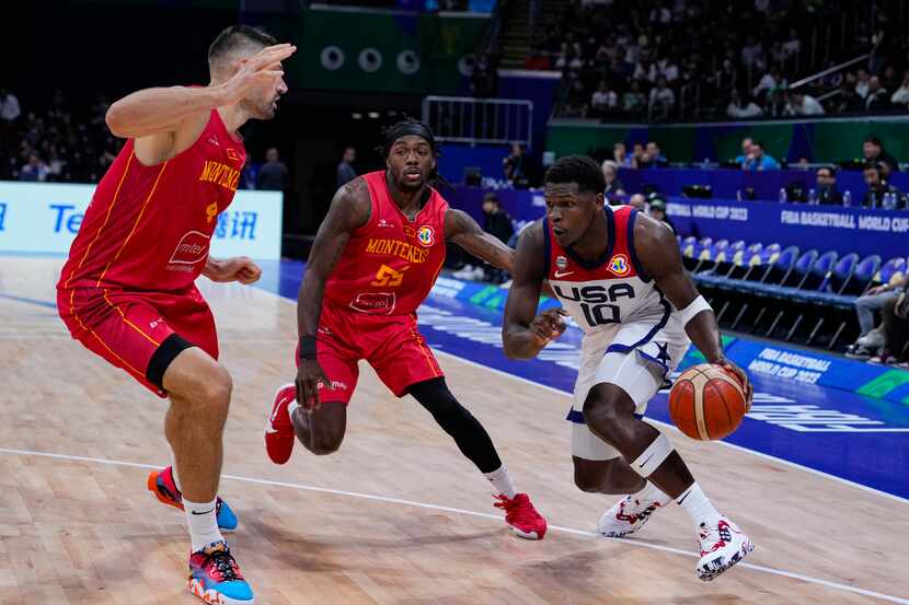 U.S. guard Anthony Edwards (10) drives on Montenegro guard Kendrick Perry (55) and center...