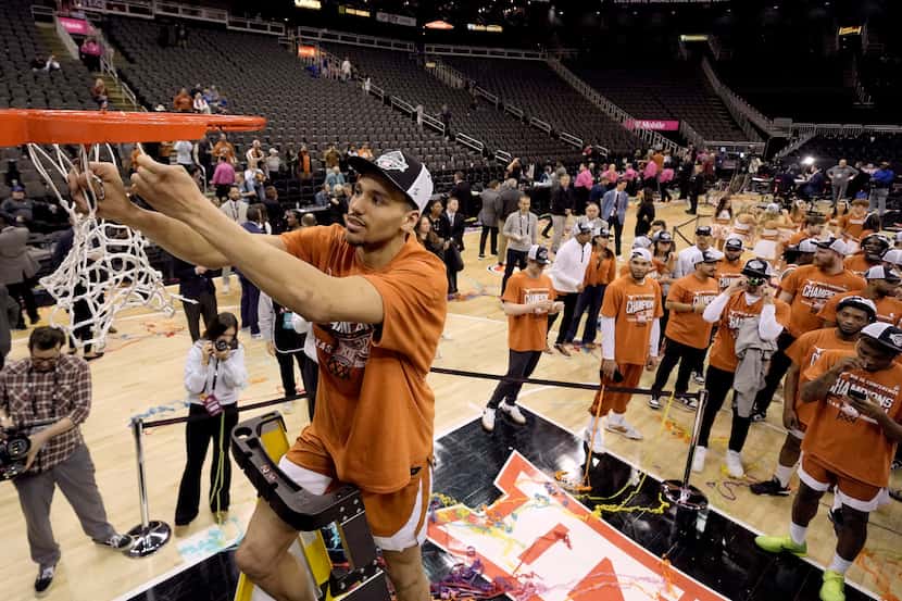 Texas forward Dylan Disu cuts the net after Texas won the Big 12 Conference tournament...