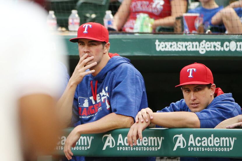 Texas Rangers starting pitcher Cole Hamels (35) and starting pitcher Derek Holland (45)...