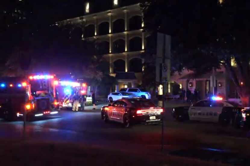 Dallas police and fire vehicles sit outside the Hotel ZaZa, where a woman was killed in a...