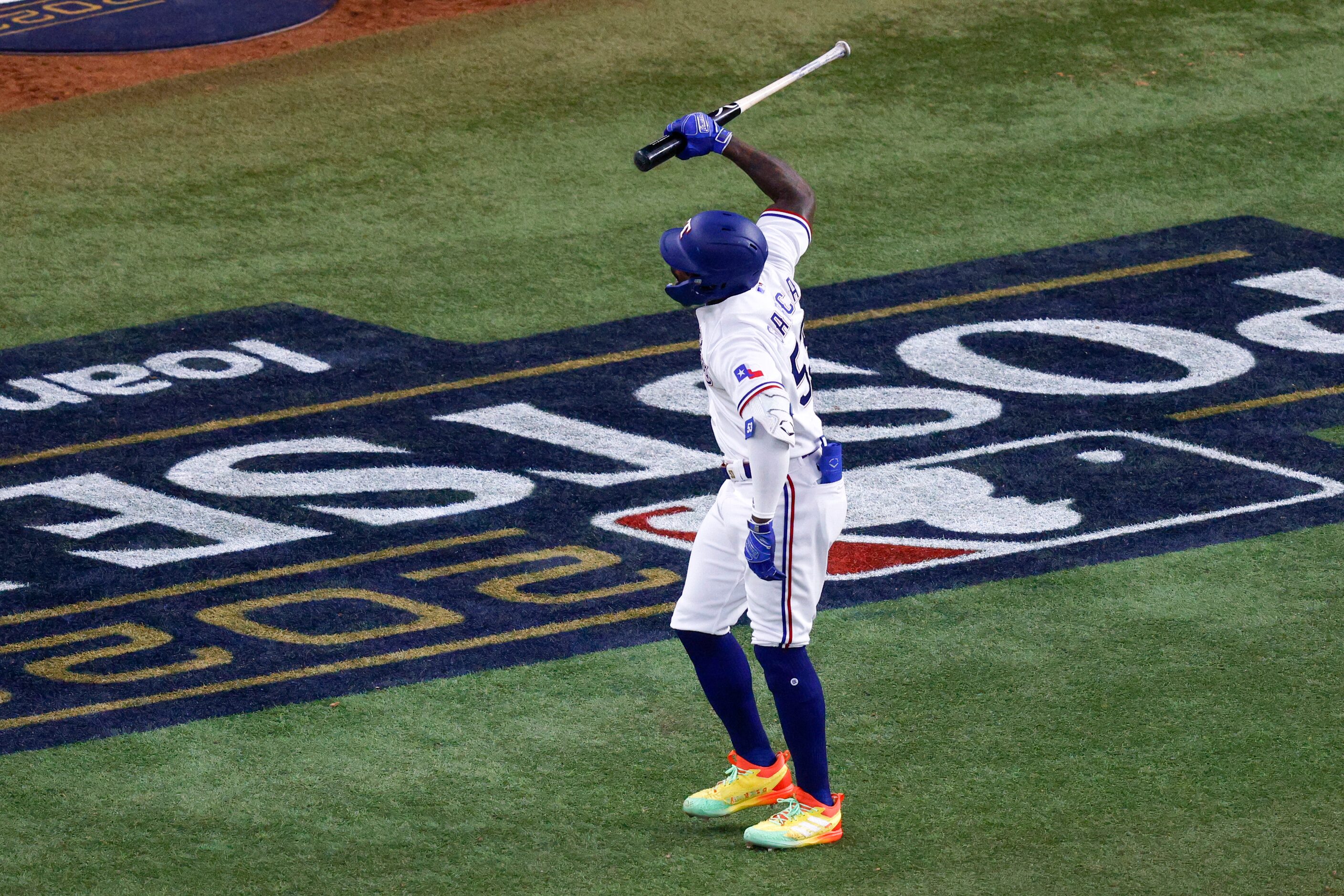 Texas Rangers right fielder Adolis Garcia (53) slams his bat into the ground after hitting a...