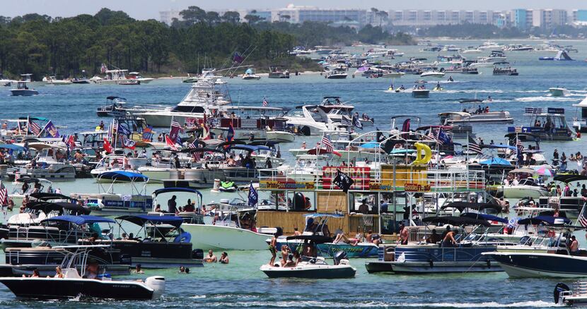 Boaters crowded an area known as "Crab Island" in the shallow waters near Destin Fla., over...