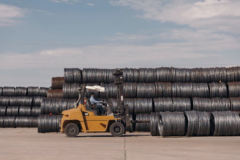 Bales of raw steel imports sit in an outdoor storage yard at the Insteel Industries factory...