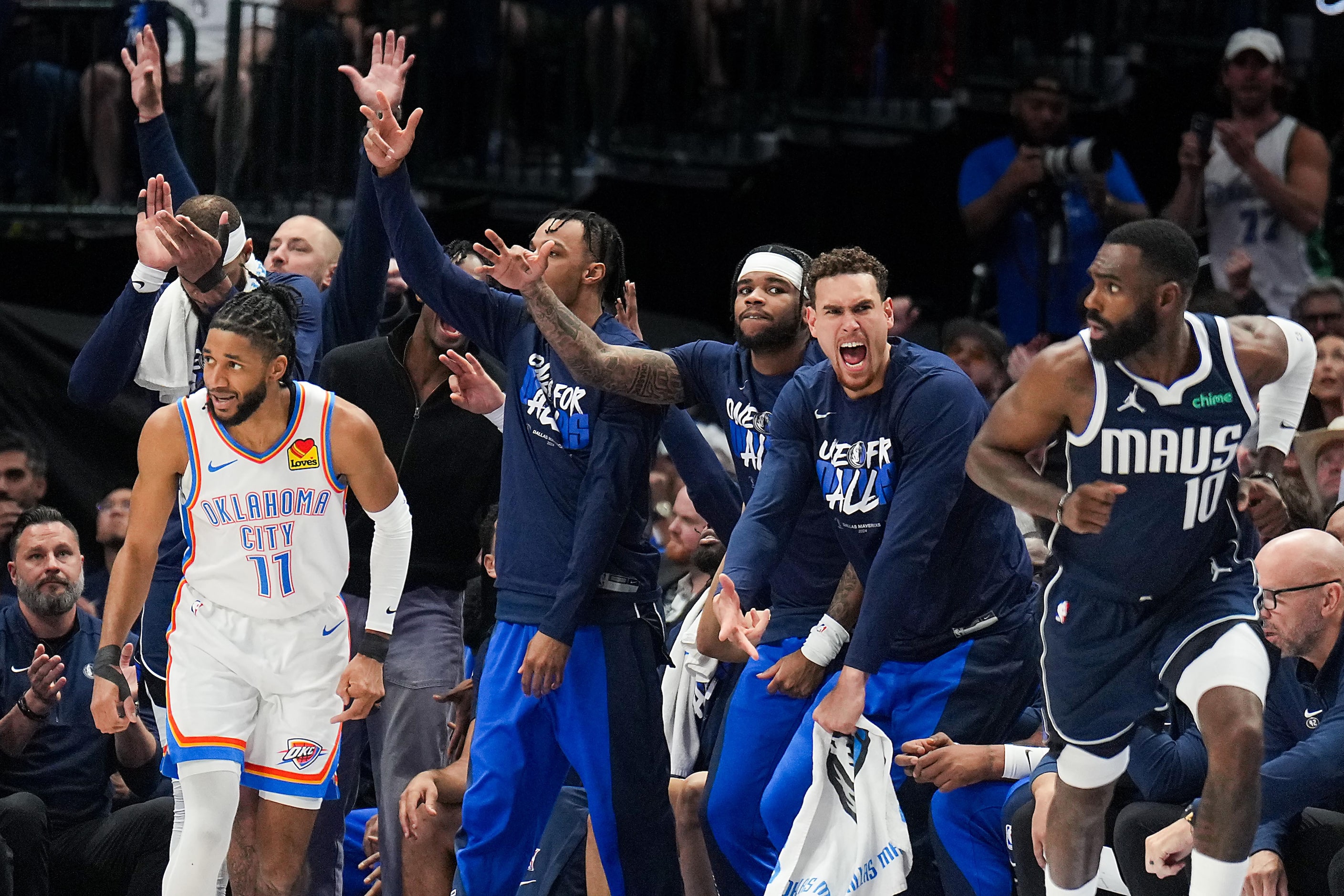 The Dallas Mavericks bench reacts after a 3-pointer by forward Tim Hardaway Jr. (10) over...