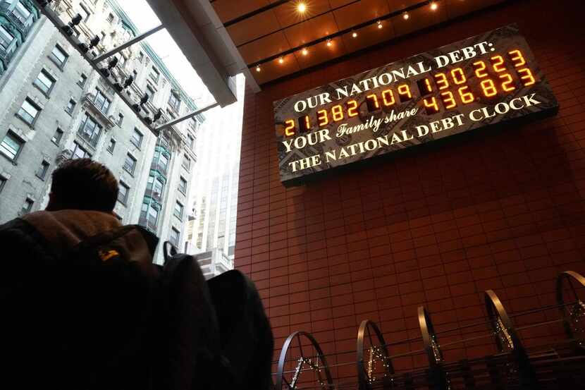 A man walks past the he National Debt Clock on 43rd Street in midtown New York City on Feb....