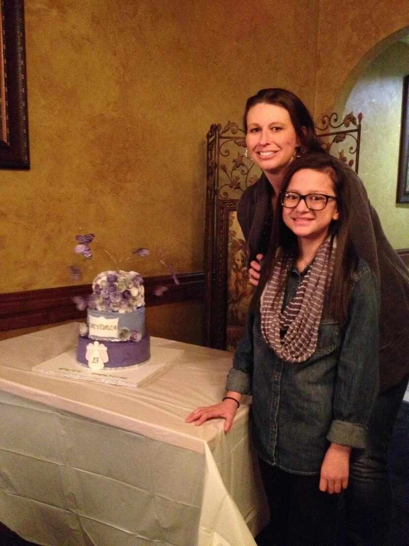 Dawn Marks Soefje  presents a cake to Victoria, right, a 13-year-old with cystic fibrosis....
