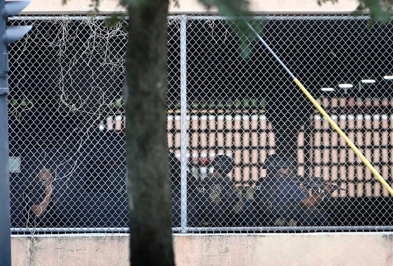 Dallas police officers searched a parking garage near their headquarters near downtown...