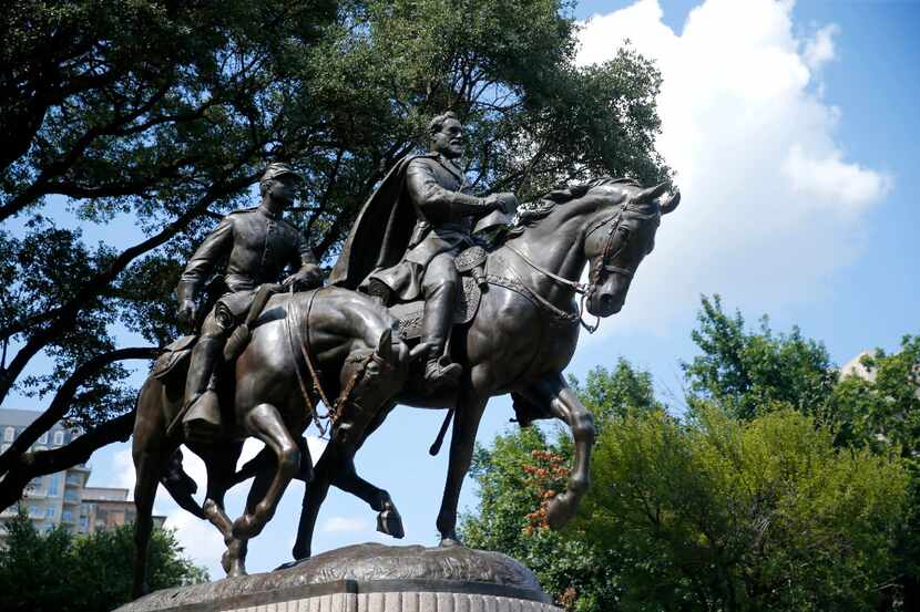 This Tuesday, July 18, 2017 photo shows a statue honoring Robert E. Lee, right, with a...