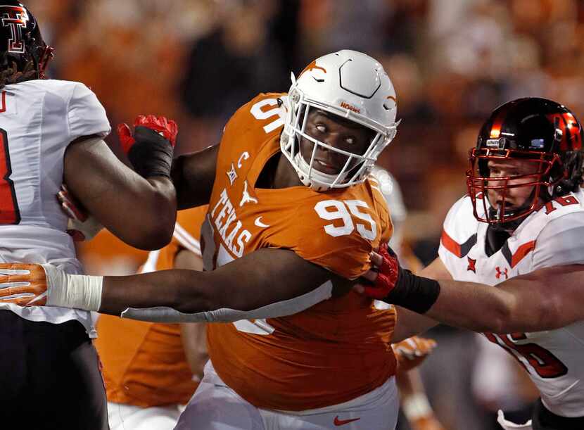 FILE - In this Nov. 24, 2017, file photo, Texas defensive lineman Poona Ford (95) rushes...