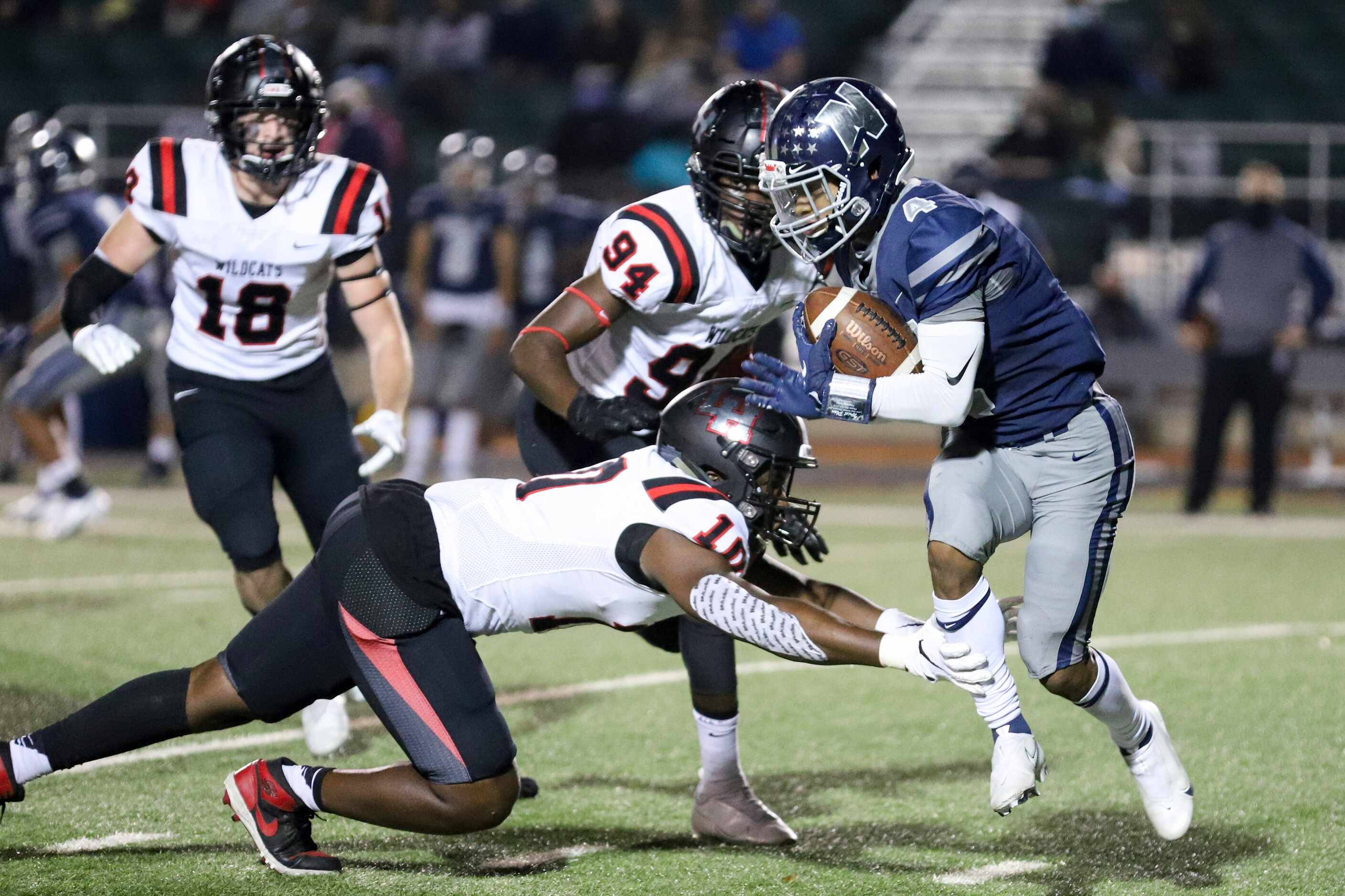 Irving Nimitz wide receiver Kavon Bartlett (4) avoids a tackle from Lake Highlands...