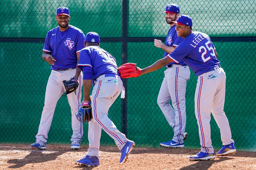 Texas Rangers pitcher Jose Leclerc (right) laughs with Edinson Volquez (36) Juan Nicasio...