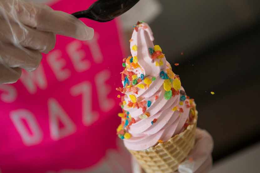 Owner Holly Nguyen, of Richardson, sprinkles Fruity Pebbles cereal soft serve at Sweet Daze...