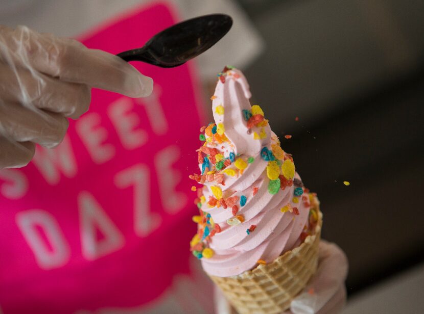 Owner Holly Nguyen, of Richardson, sprinkles Fruity Pebbles cereal soft serve at Sweet Daze...