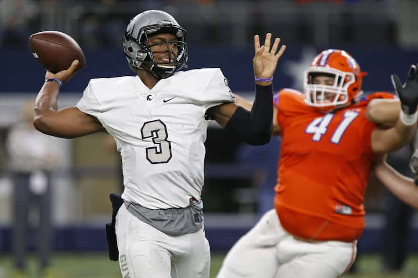 Denton Guyer High School quarterback Shawn Robinson (3) throws a pass as he is pressured by...