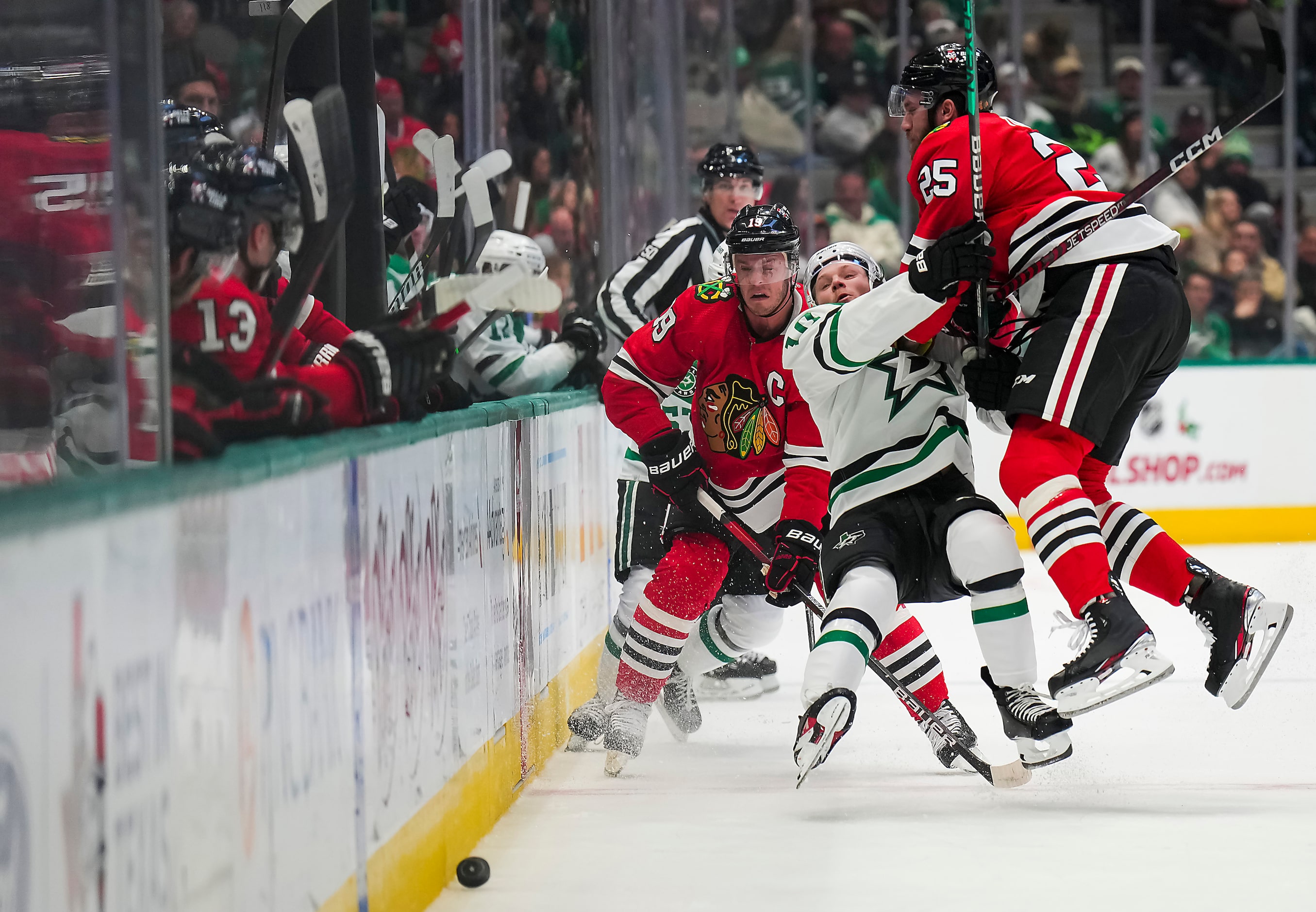 Dallas Stars center Ty Dellandrea (10) is knocked to the ice by Chicago Blackhawks...