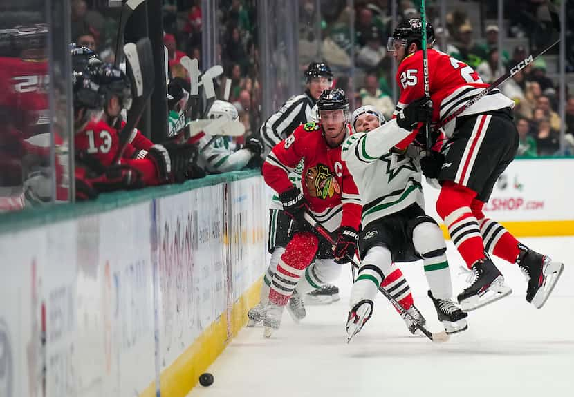 Dallas Stars center Ty Dellandrea (10) is knocked to the ice by Chicago Blackhawks...