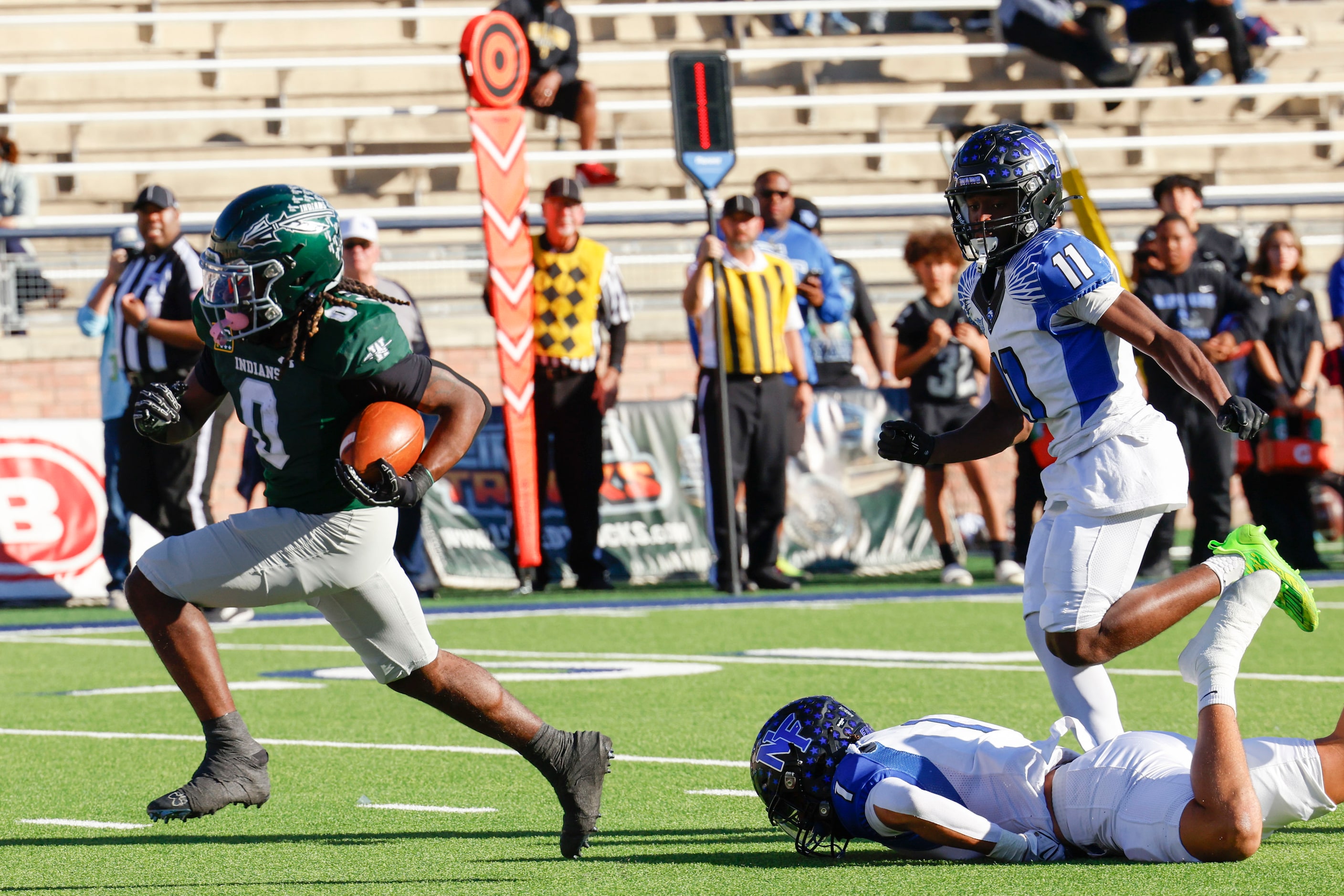 Waxahachie High’s Bryson Linnear (left) runs a touchdown past North Forney’s Caleb Holt (1) ...