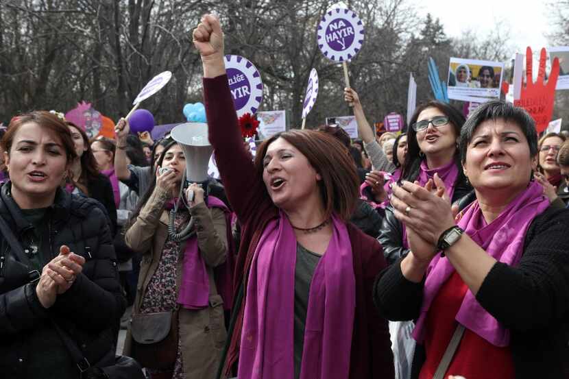 Women shout slogans and hold banners as they demonstrate in central Ankara to commemorate...