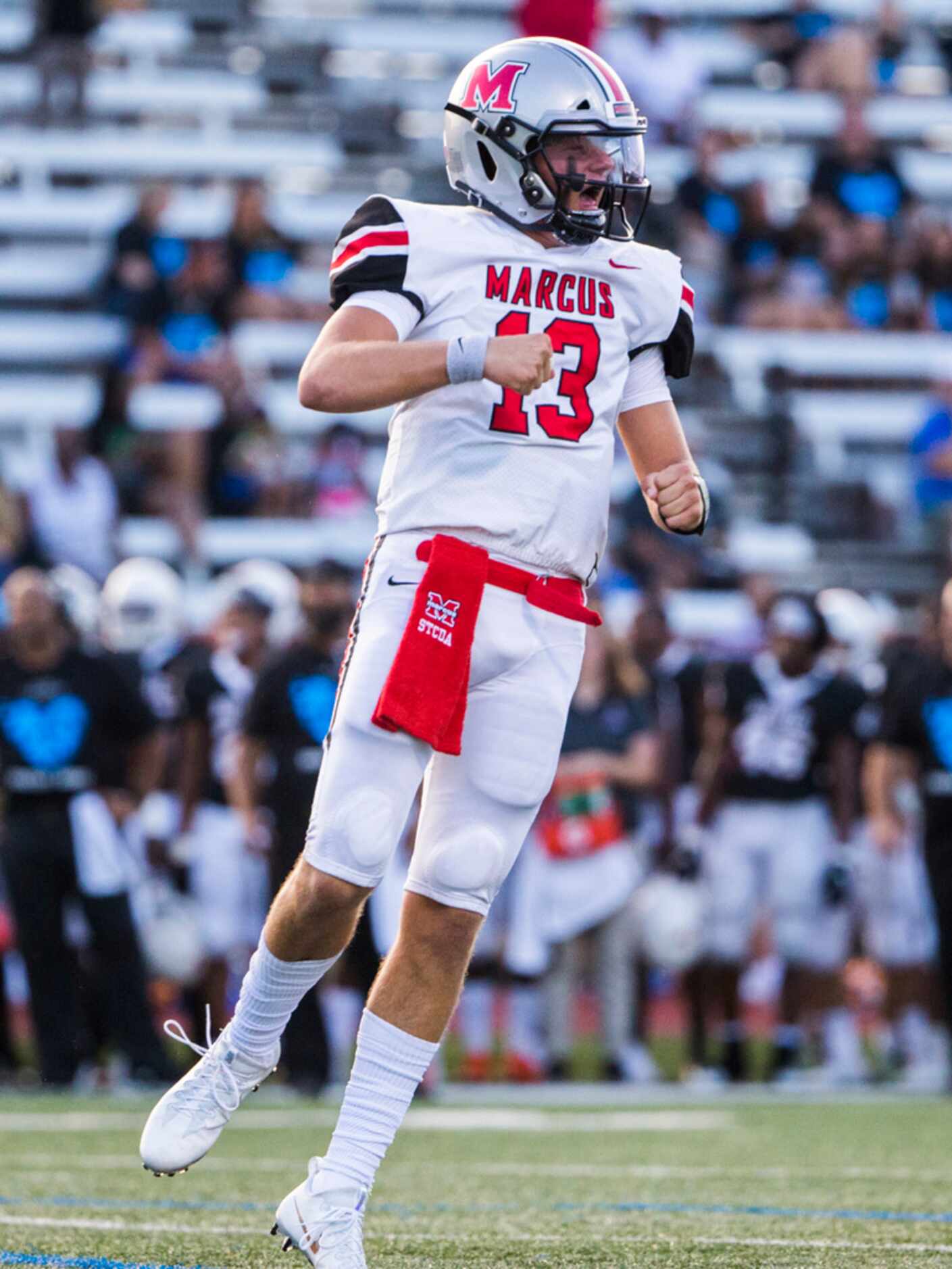 Flower Mound Marcus quarterback Garrett Nussmeier (13) celebrates after a touchdown during...