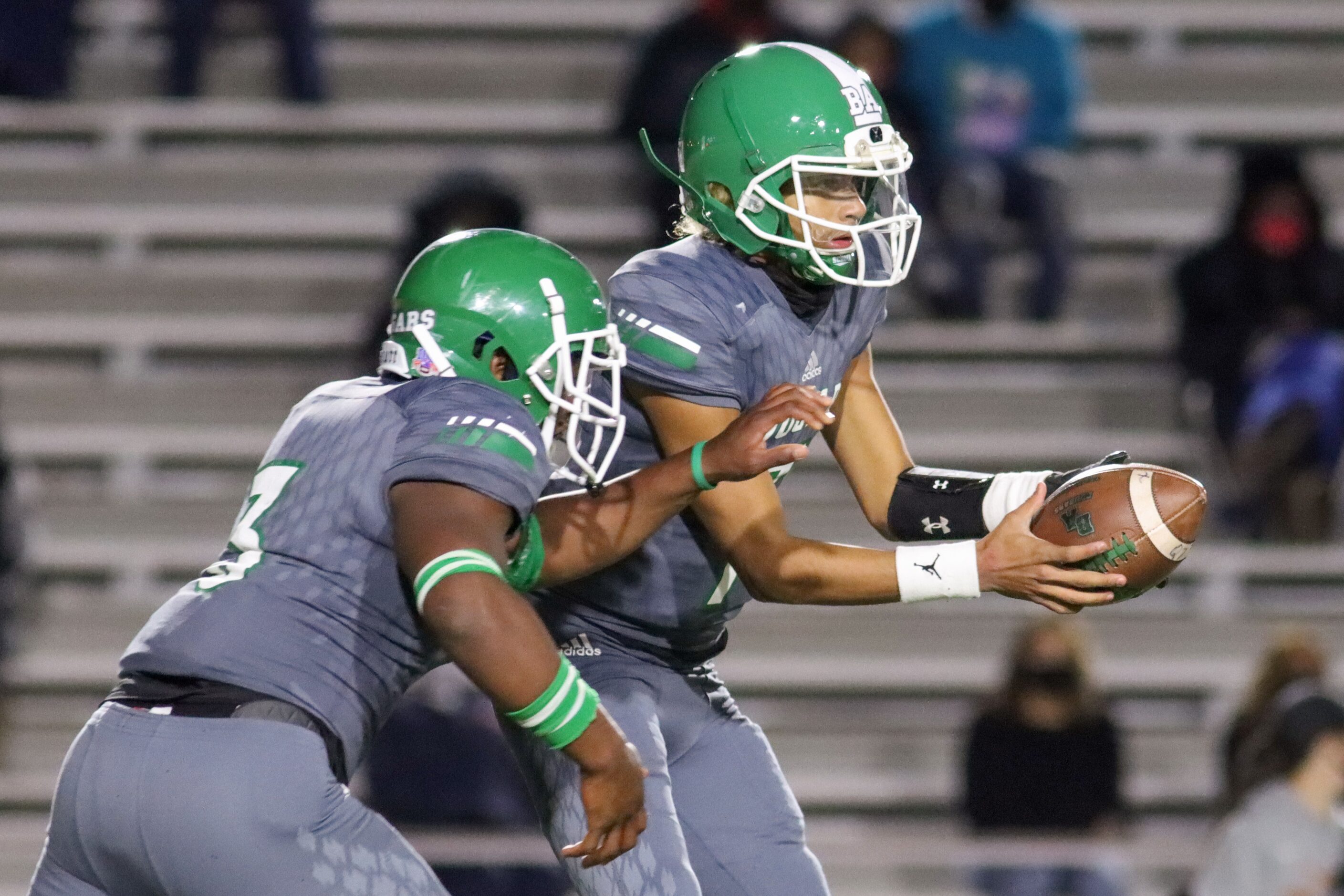 Bryan Adams quarterback Rayvon Jackson (7) hands the ball to running back Andre Reece (3)...