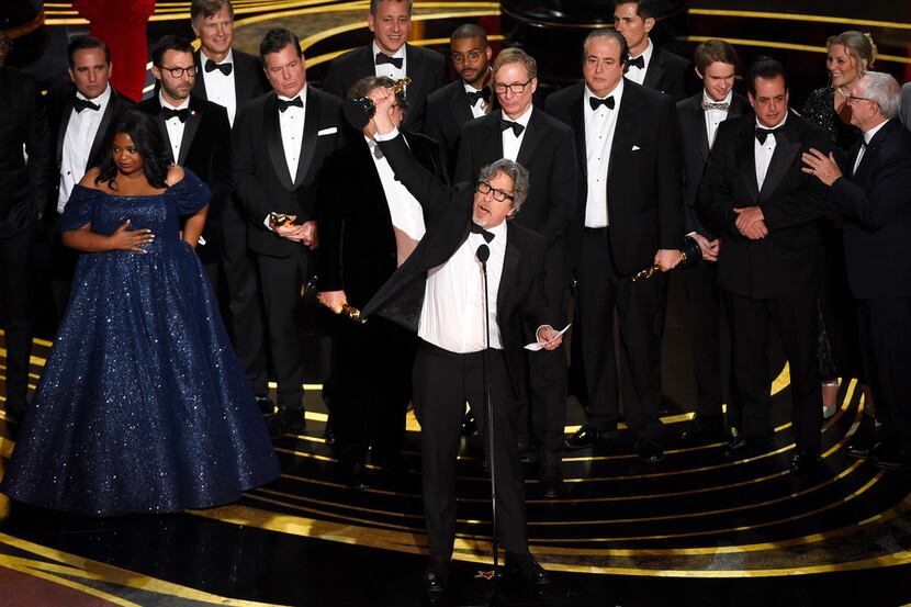 Peter Farrelly (center) and the cast and crew of Green Book accept the award for best...