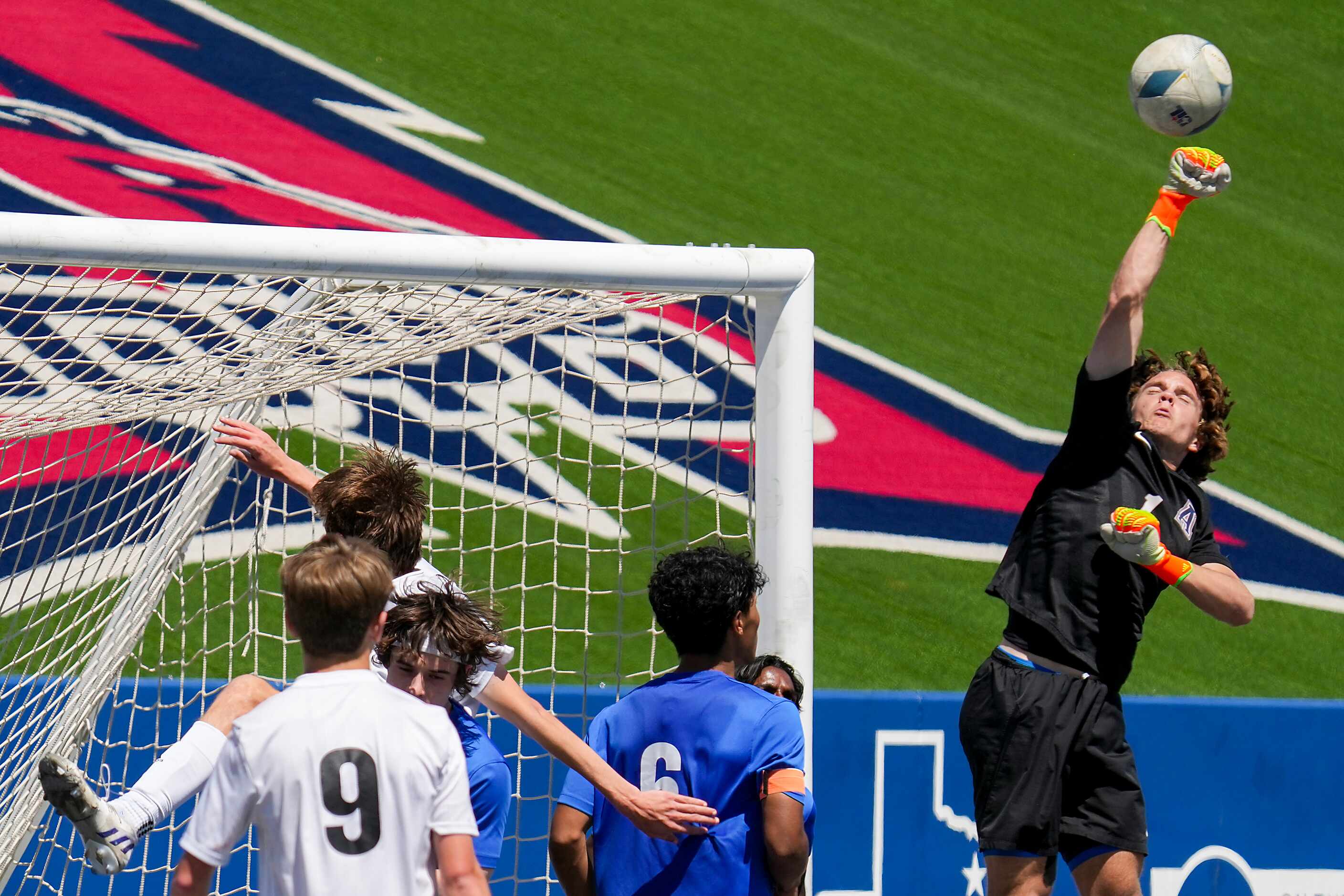 Allen goalkeeper Alec Setterberg (1) punches a Lake Highlands cross away from the net during...