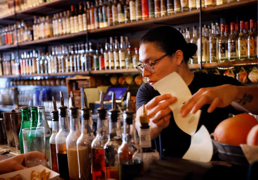 Pablo De La Rosa takes an order and prepares drinks for patrons at Las Almas Rotas in the...