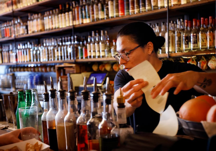 Pablo De La Rosa takes an order and prepares drinks for patrons at Las Almas Rotas in the...