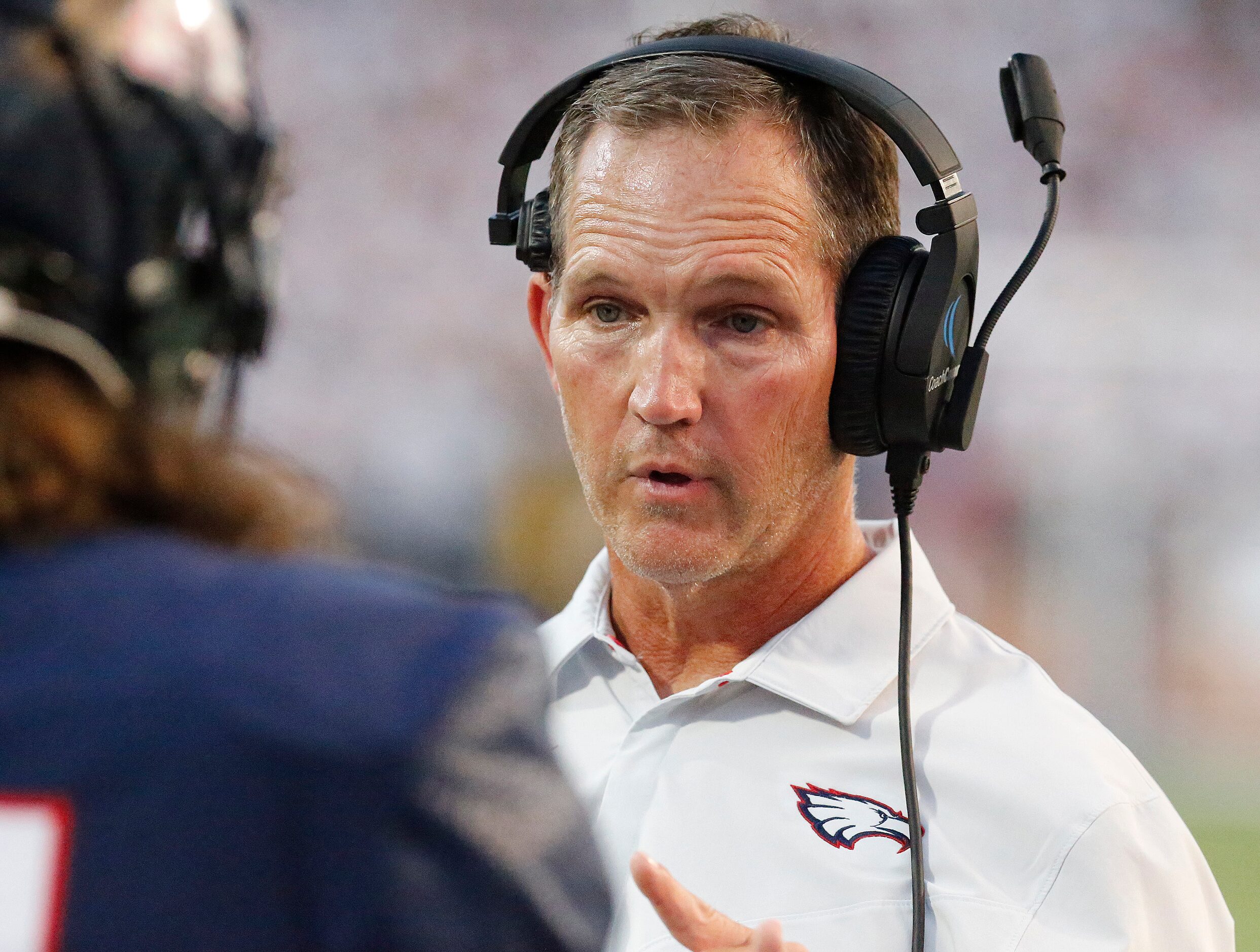 Allen High School head coach Lee Wiginton talks to a player during the first half as Allen...