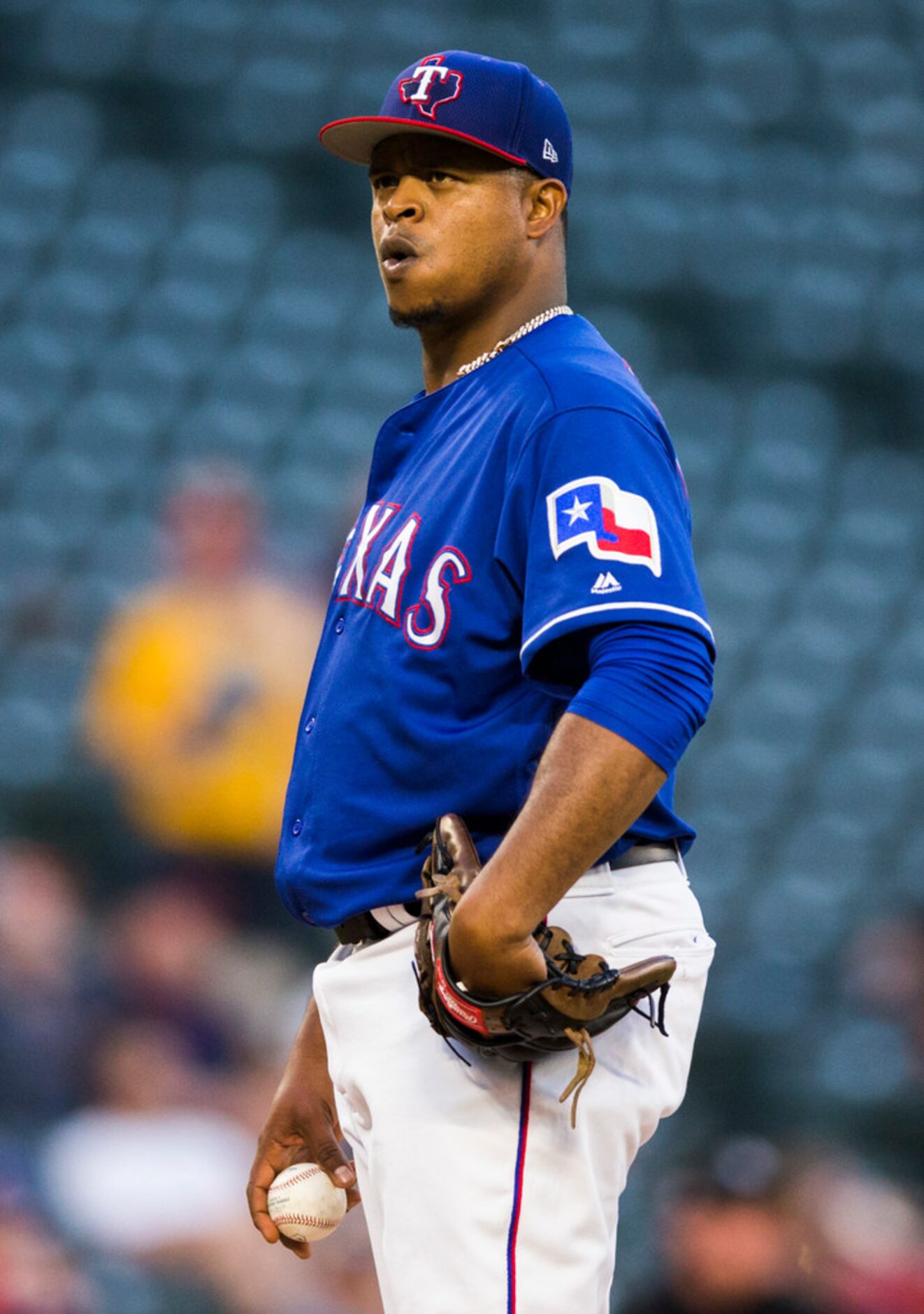 Texas Rangers starting pitcher Edinson Volquez (36) takes a breath on the mound during the...