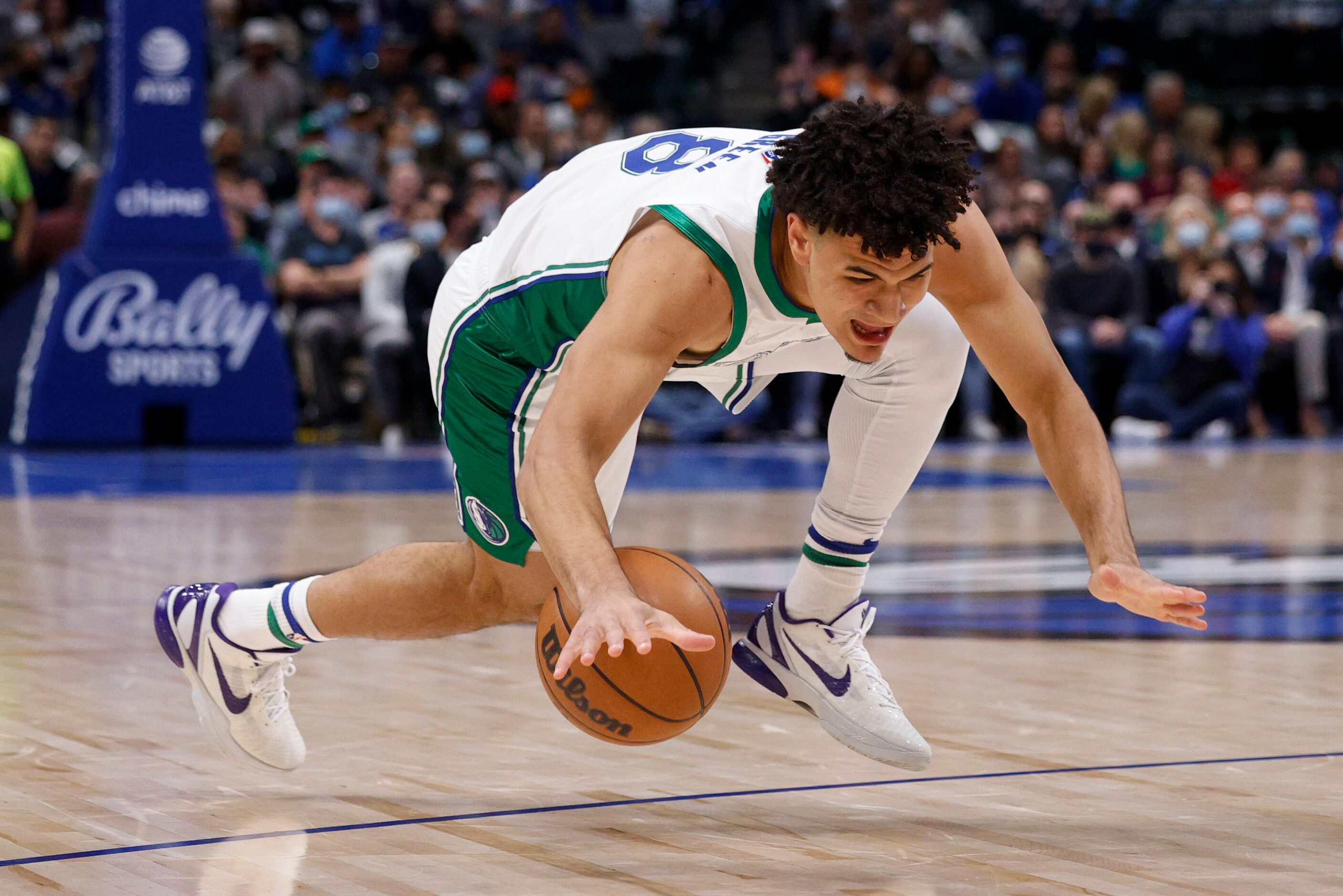 Dallas Mavericks forward George King (8) trips while handling the ball during the first...