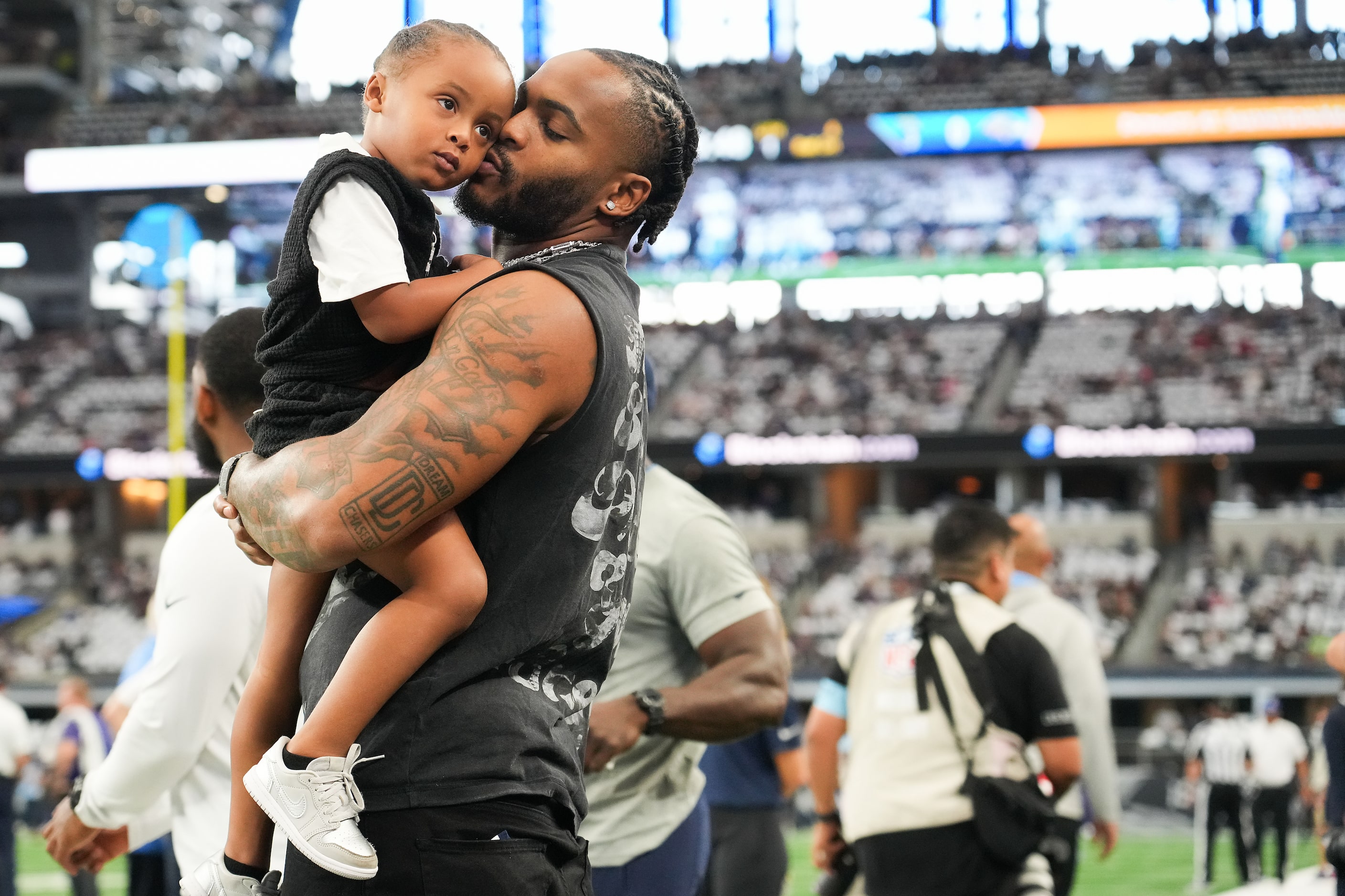 Injured Dallas Cowboys defensive end Sam Williams watches the teams warm up before an NFL...