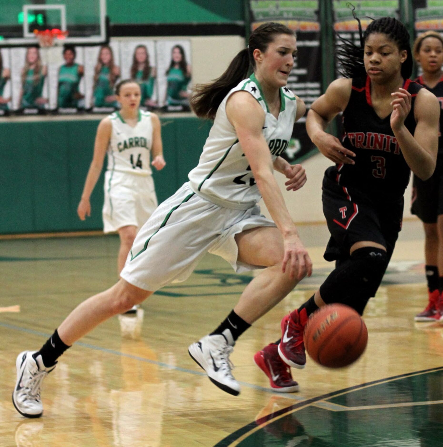 Southlake Carroll forward Priscilla Smeenge (23) drives hard to the basket past the defense...