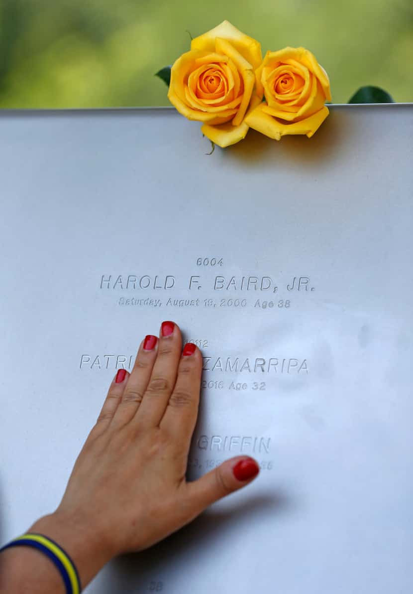 Isabel Zamarripa touches the engraved name of her nephew Patrick Zamarripa, one of five...