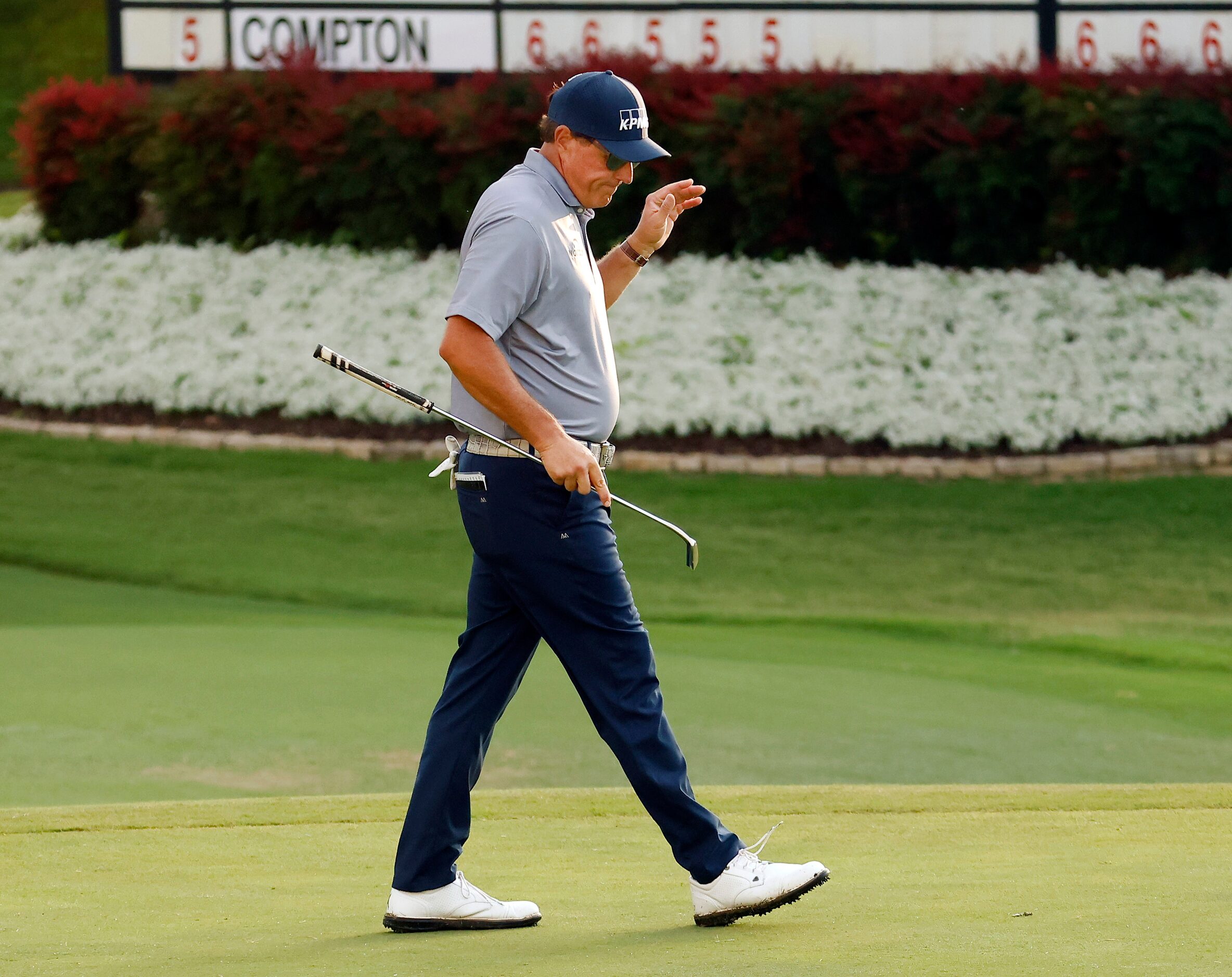 Professional golfer Phil Mickelson reacts after missing his par putt and the cut on No. 18...