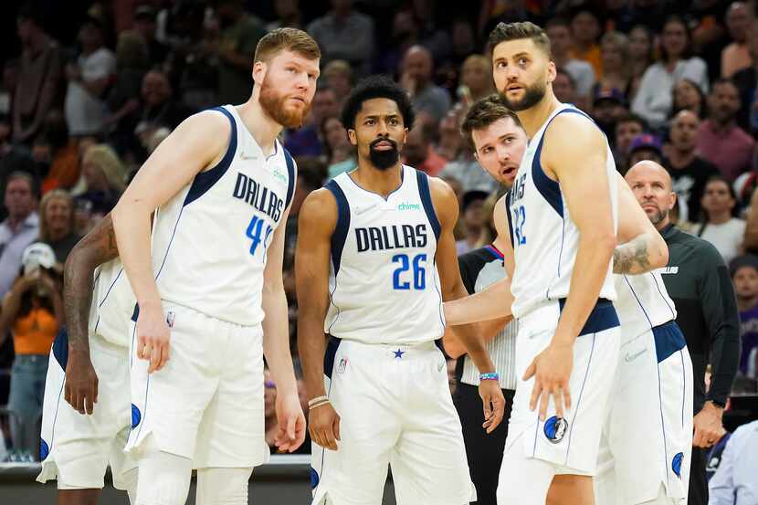 Dallas Mavericks players forward Davis Bertans (44), guard Spencer Dinwiddie (26), guard...