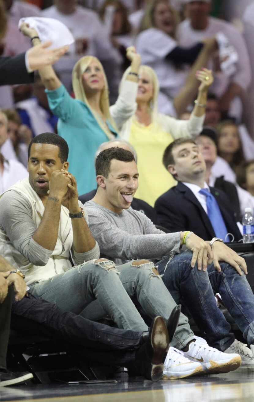 Cleveland Browns quarterback Johnny Manziel reacts after Cleveland Cavaliers' LeBron James...