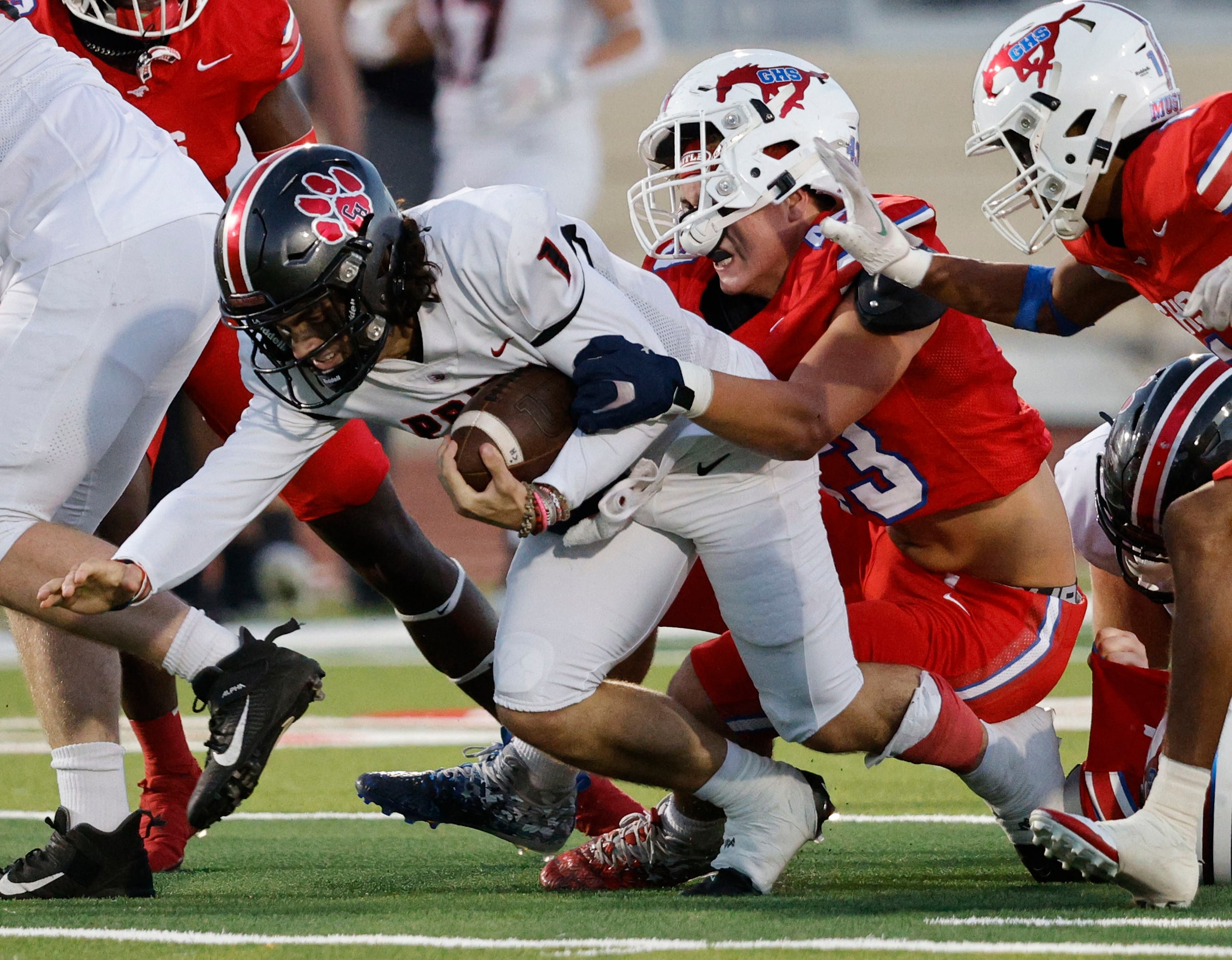 Grapevine's Bradley Stanyer (43), center, and Grapevine's Bryson Davis (1) go to stop...