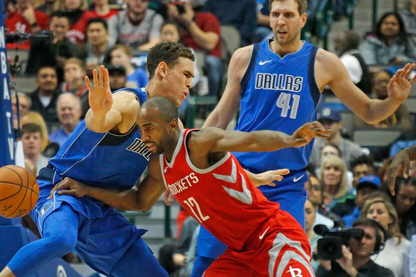 The Dallas Mavericks' Dwight Powell (7)collides with the Houston Rockets' Luc Mbah a Moute...