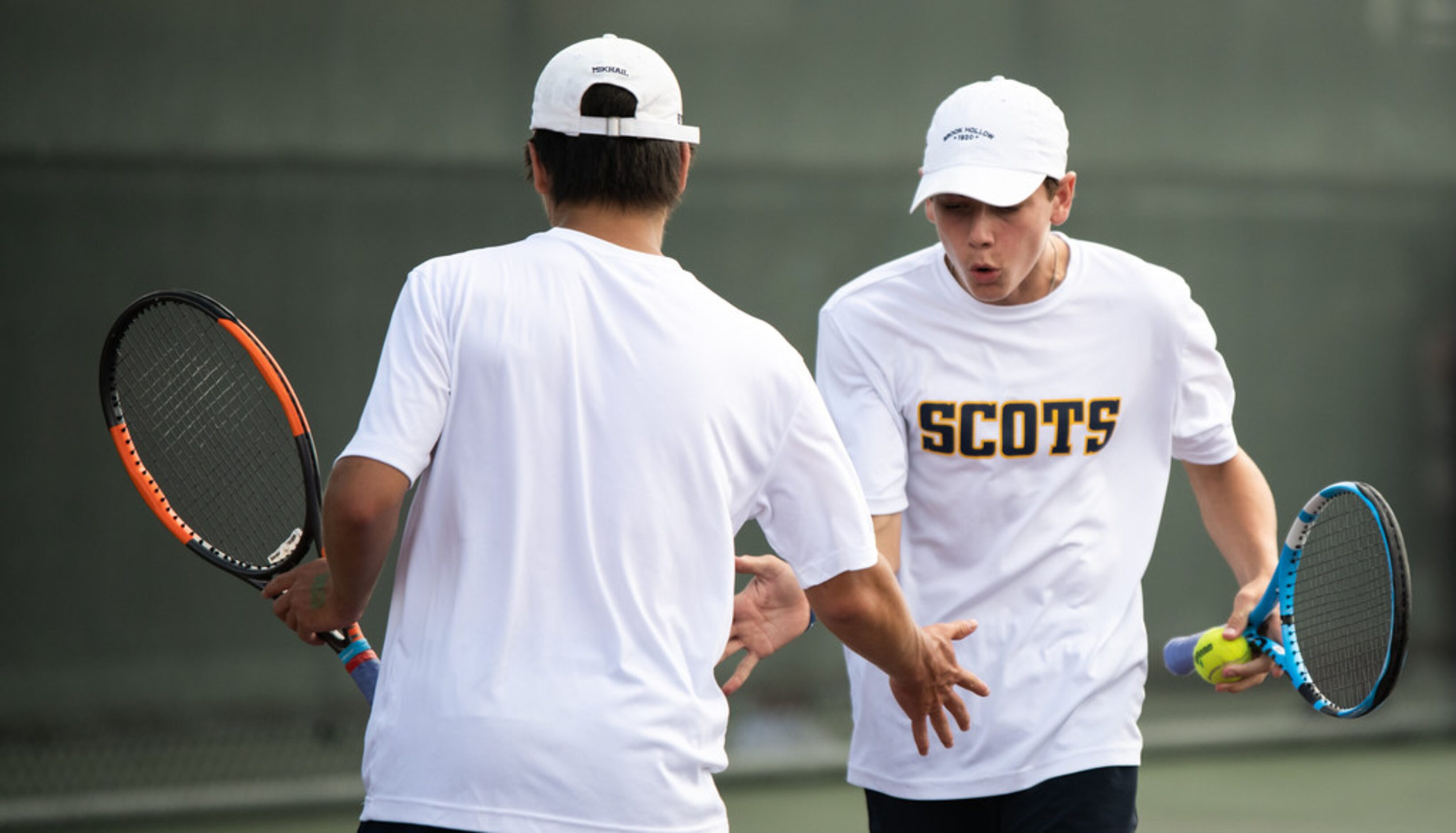 Highland Park's Ray Saalfield and Mikhail Commer high five during a doubles match against...