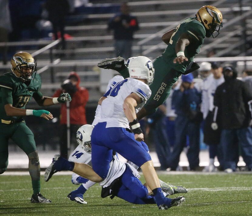 DeSoto running back Keylan Chapman (2) leaps over Midlothian defensive back Cedric Whitaker...