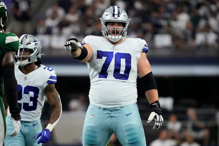 Dallas Cowboys guard Zack Martin (70) gestures at the line of scrimmage during the first...