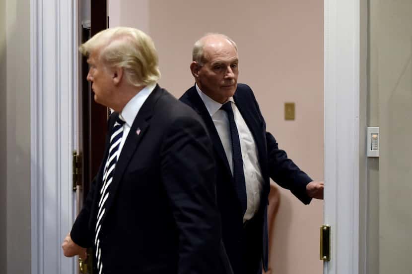 Chief of staff John Kelly (right) holds the door for President Donald Trump during an event...