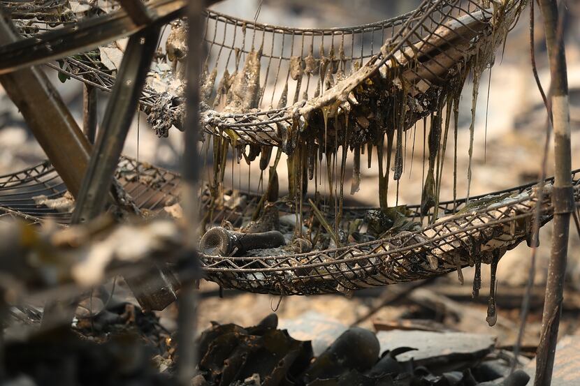 Burned out wine bottles sit on a rack at the fire damaged Signarello Estate winery after an...