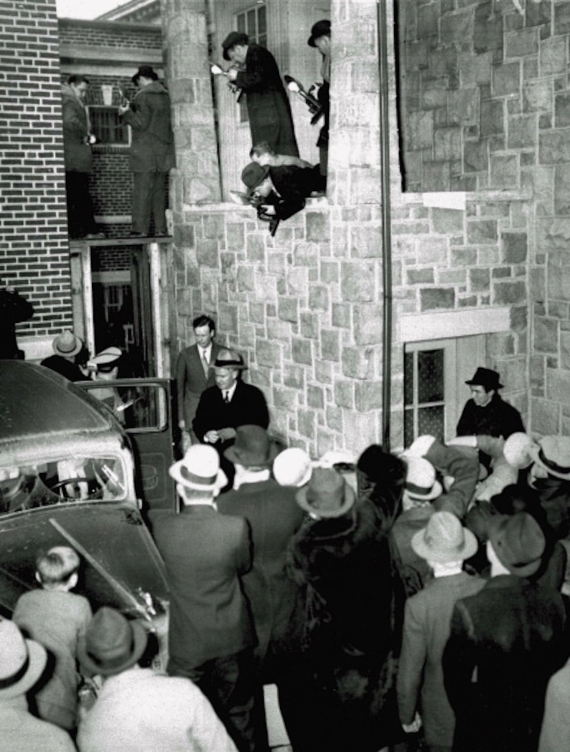 Photographers perched in every vantage point follow aviator Charles A. Lindbergh, center...