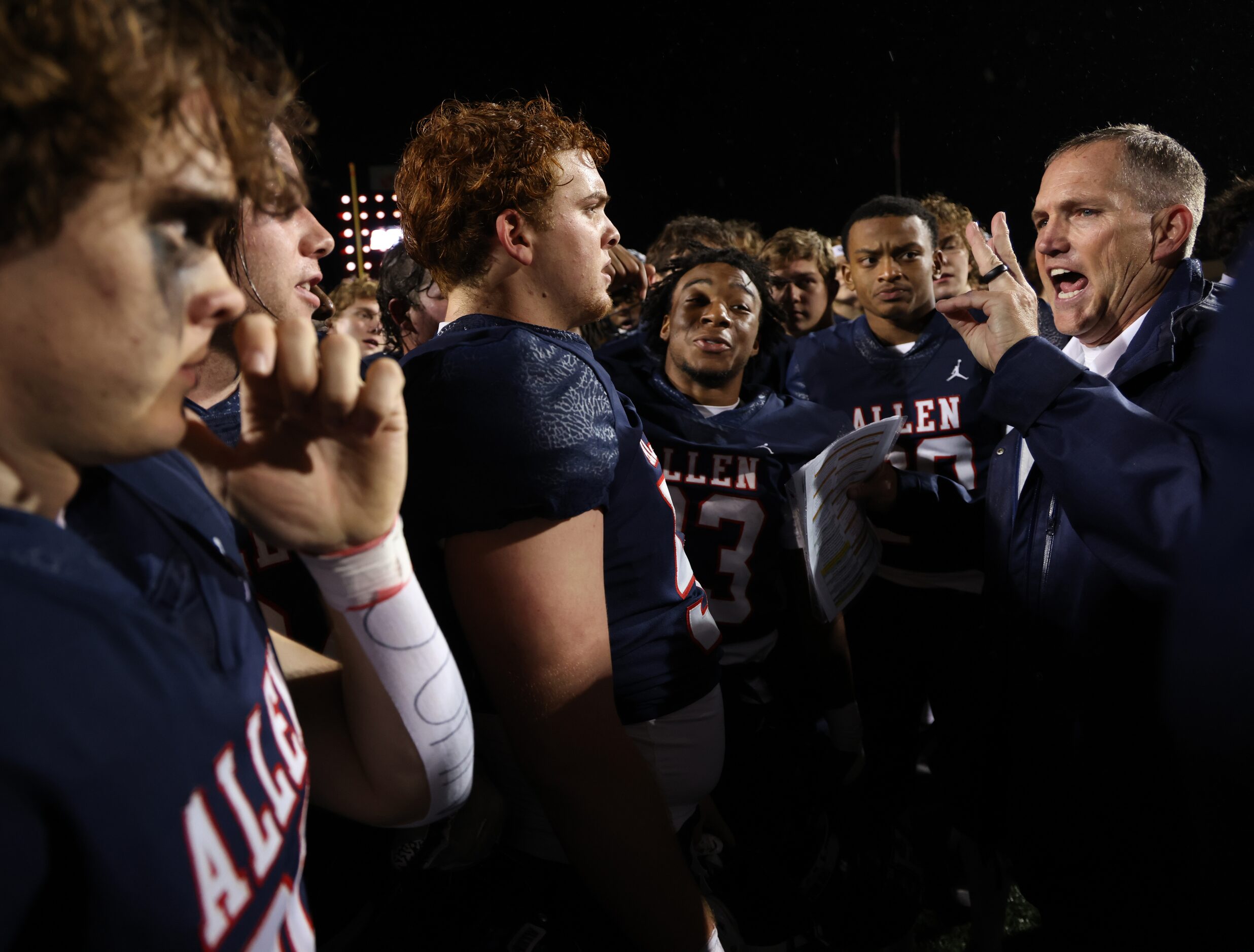 Allen head coach Lee Wiginton, right, speaks with his players following the team's 1-point...